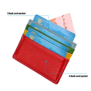 Detail view of red lychee grain leather card holder with multi-colored interior slots