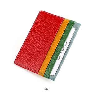 Detailed side view of multi-color leather card holder with pebbled texture and neat stitching