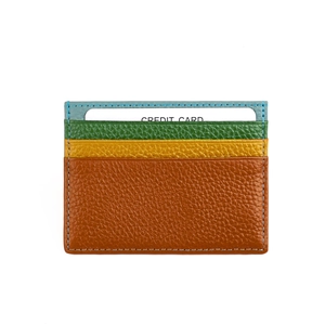 Macro view of multi-color leather card holder with textured finish and fine blue stitching