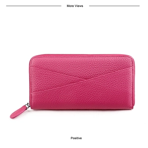 Détail du portefeuille long magenta en cuir véritable avec texture grainée et fermeture éclair