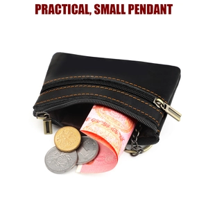 Detailed view of black leather coin purse with double zippers and orange stitching