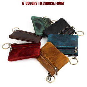 Flat lay of genuine leather coin pouches in six vintage colors with metal key rings