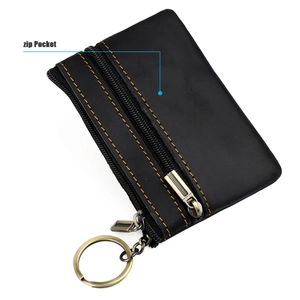 Detail of black leather coin purse with yellow stitching and dual zip pockets