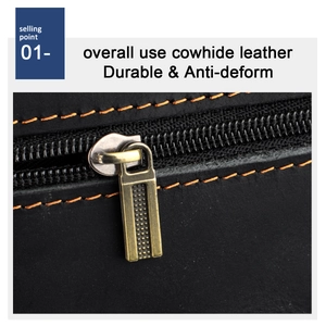 Detail of durable black cowhide leather with orange stitching and brass zipper puller