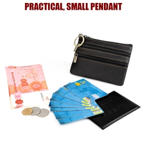 Detail view of leather wallet with three zipper pockets holding cards, cash and coins