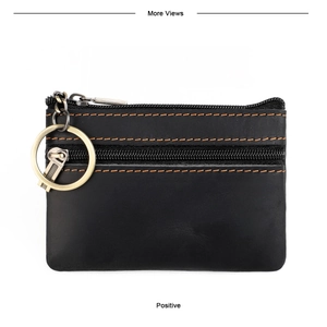 Detail of black leather coin purse with orange stitching and gold metal keyring