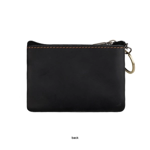 Detail view showing black textured leather coin purse with contrast yellow stitching