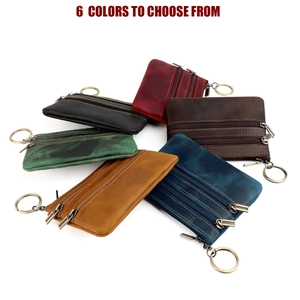 Top-down view of six vintage crazy horse leather wallets with brass keyrings in various colors