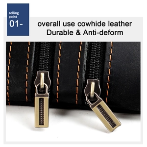 Close-up of black crazy horse leather wallet with orange stitching and vintage brass zipper
