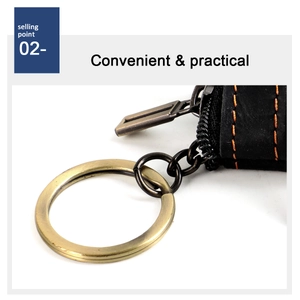 Detail of crazy horse leather key pouch with orange contrast stitching and brass ring