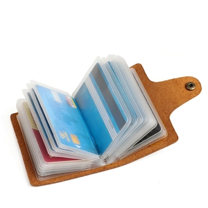 Detail view of brown crazy horse leather card holder with multiple PVC slots and metal button