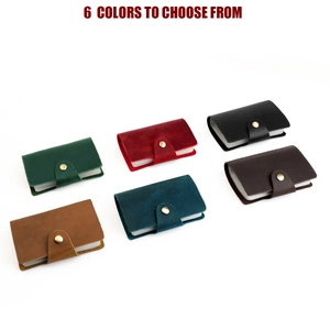 Top view of compact leather card holders in six vintage colors with metal snaps