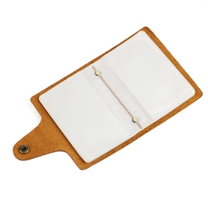 Detail view of vintage brown leather card holder with internal transparent PVC slots