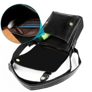 Detail view showing organized interior of black leather crossbody bag with multiple card slots