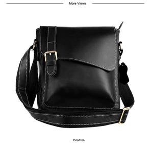 Detail view of black vintage leather messenger bag with white stitching and brass buckle