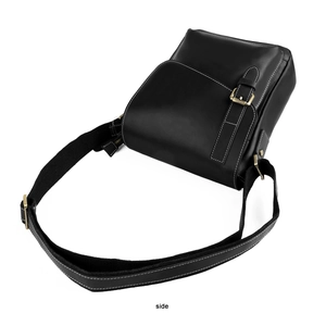 Detail view of black vintage leather messenger bag with white stitching and metal buckle