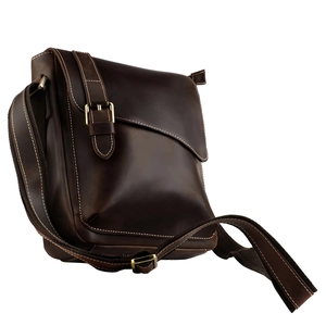 Close-up of vintage brown leather bag featuring adjustable strap and bronze buckle detail