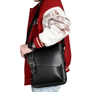 Vintage black crazy horse leather messenger bag with contrast stitching and metal buckle