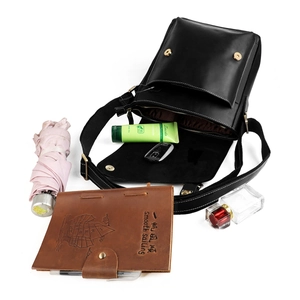 Vintage black crazy horse leather messenger bag with flap closure and lifestyle items