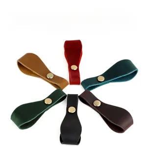 Detailed view of colorful leather keychains with golden clasps in star arrangement