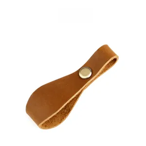 Detail of crazy horse leather strap with brass snap button for outdoor camping gear
