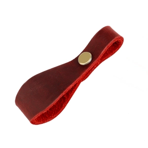 Detailed macro view of crazy horse leather strap with a vintage brass metal rivet