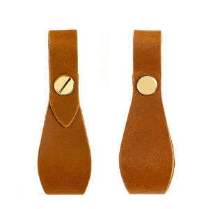 Set of two crazy horse leather drawer pulls with brass hardware on a white background