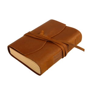 Macro view of retro handmade crazy horse leather notebook with strap closure
