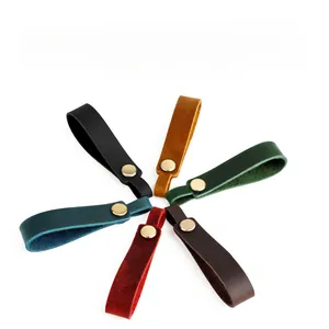 Detail of crazy horse leather keychains in six colors with gold snap buttons