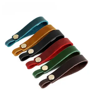 Detail of vintage genuine leather keychains in six colors with brass metal snap buttons