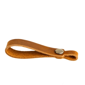 Detail of vintage brown crazy horse leather strap with antique bronze metal snap button