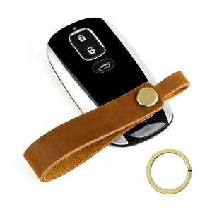 Vintage brown crazy horse leather keychain with brass snap button on a white background