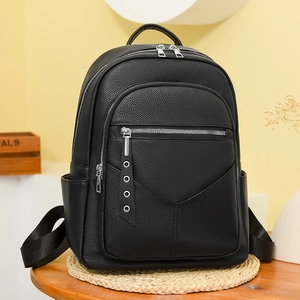 Close-up of black litchi pattern PU leather backpack with metallic eyelet zipper pulls