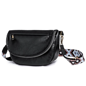 Detailed view of black PU leather texture with bronze hardware and woven strap