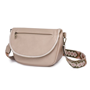 Detail view of beige crossbody bag featuring vintage embroidery strap and zipper pocket