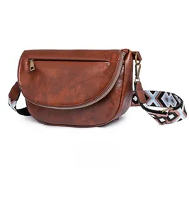 Brown vintage chest bag featuring textured leather and a colorful jacquard strap