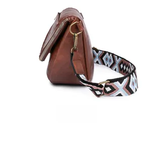 Detail of brown litchi pattern leather bag side view with vintage geometric strap