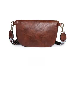 Rear view of brown vintage semi-circular crossbody bag with colorful woven shoulder strap