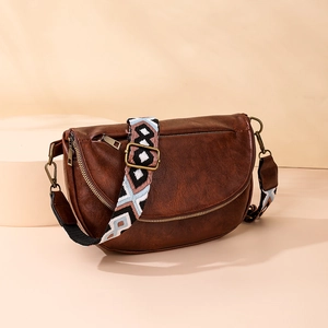 Detail view of brown vintage PU leather chest bag with Bohemian geometric pattern strap