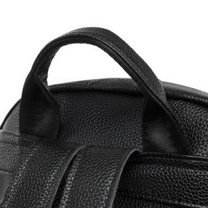 Macro view of pebble grain PU leather backpack with reinforced top handle and straps