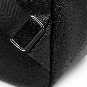Detailed macro view of black lychee grain leather texture and silver D-ring hardware