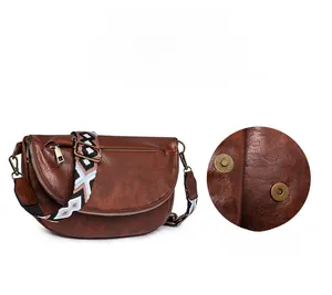 Detail view of the brown vintage crossbody bag featuring a magnetic folding flap closure