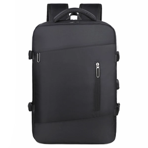 Detail of expandable black business backpack showing side compression buckles and matte texture
