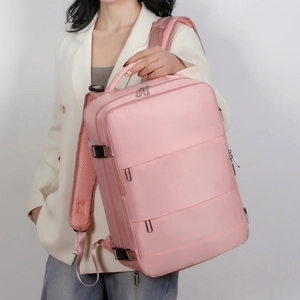 Detailed view of pink waterproof backpack with breathable mesh straps and multiple pockets