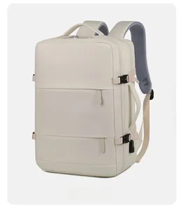 Side view of beige travel backpack showing side handle, buckle straps, and USB charging port