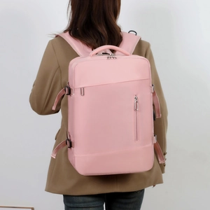 Pink waterproof commuter laptop backpack with large capacity shown on person
