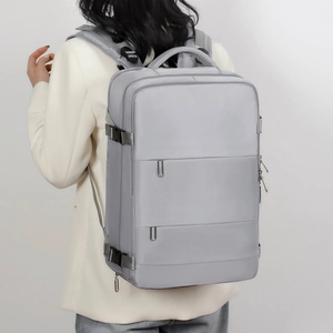 Detail of adjustable side straps and buckle on large grey business travel backpack