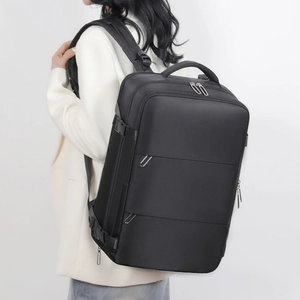 Side view of a large black business laptop backpack with ergonomic padded straps on a model