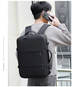 Detail of black business backpack featuring integrated USB charging port and side handle