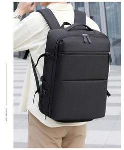 Outdoor shot of a man wearing a large black business backpack with ergonomic straps